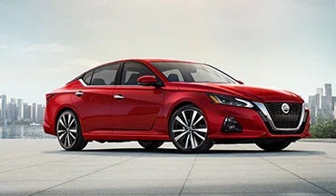 2023 Nissan Altima in red with city in background illustrating last year's 2022 model in Fort Worth Nissan in Fort Worth TX