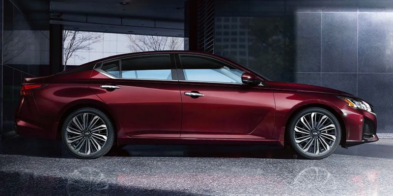 A maroon car sitting parked.