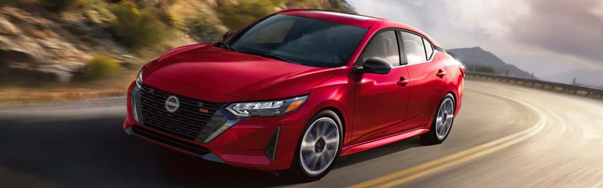 A red car driving on the road.