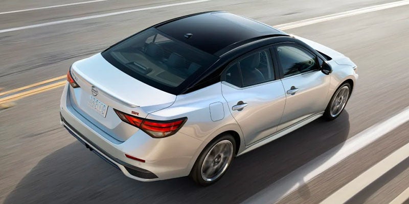 A white car driving on the road.