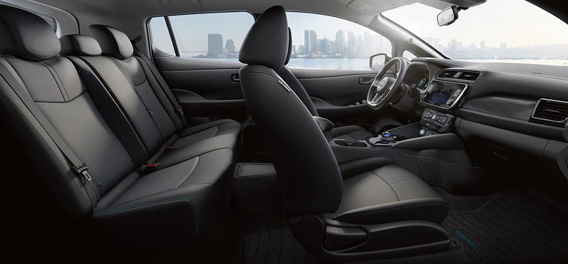 A view of the spacious and modern interior of the 2025 Nissan Leaf, featuring comfortable seating and a sleek dashboard design.