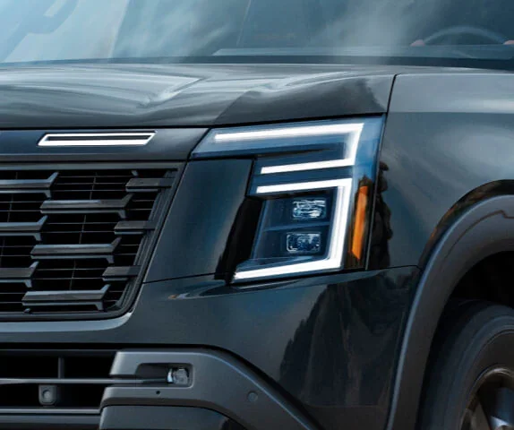 the front LED headlights and grille of a 2025 nissan armada suv