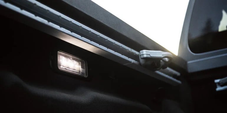 Close-up view of the 2025 Nissan Frontier's bed lighting system, showcasing its practicality for nighttime use.