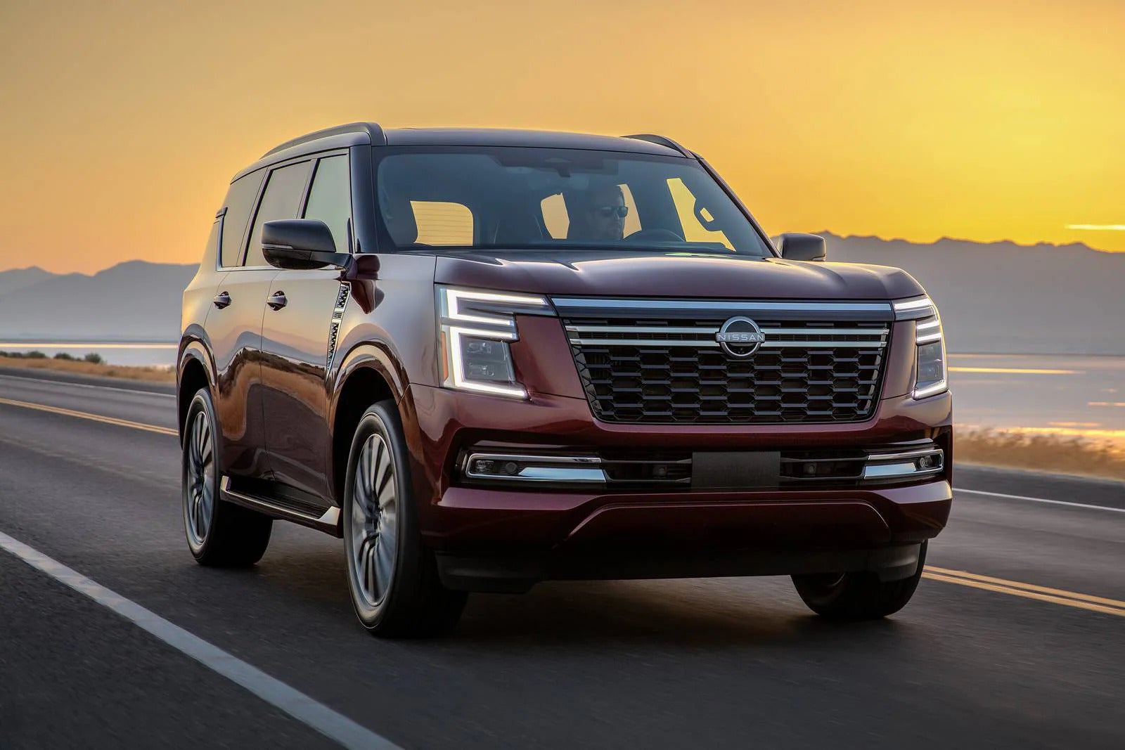 A red car driving on the road.