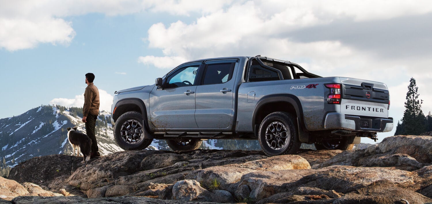 A silver truck sitting parked.