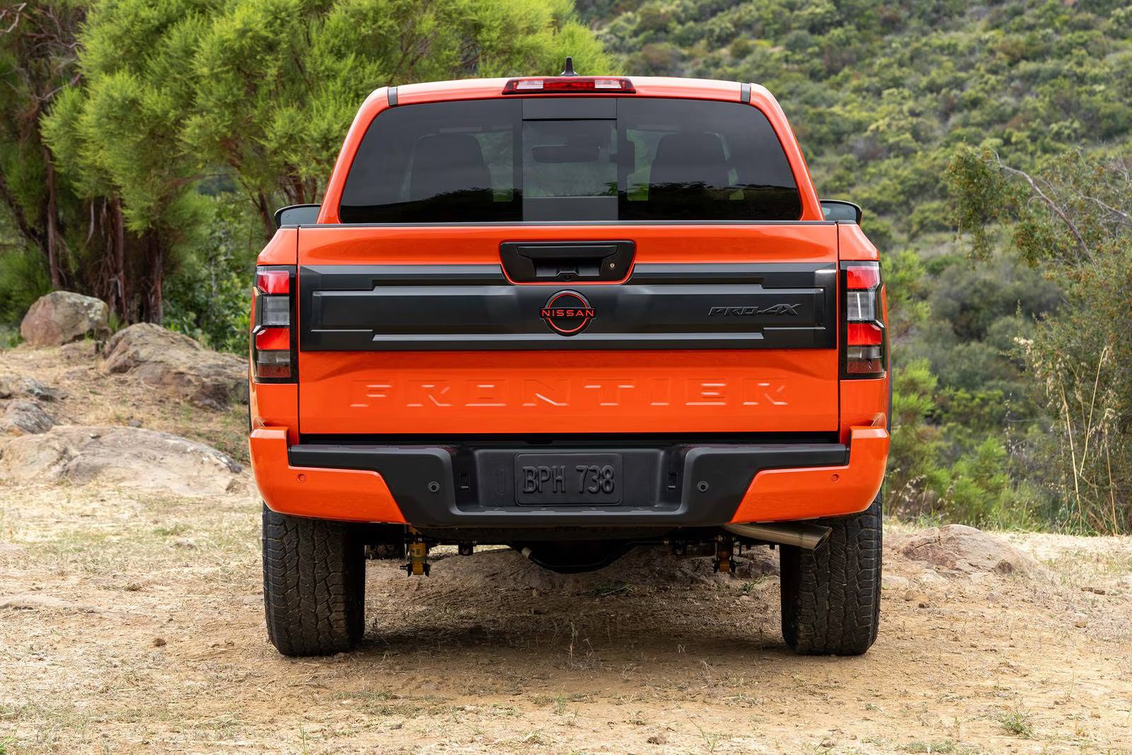 An orange truck sitting parked.