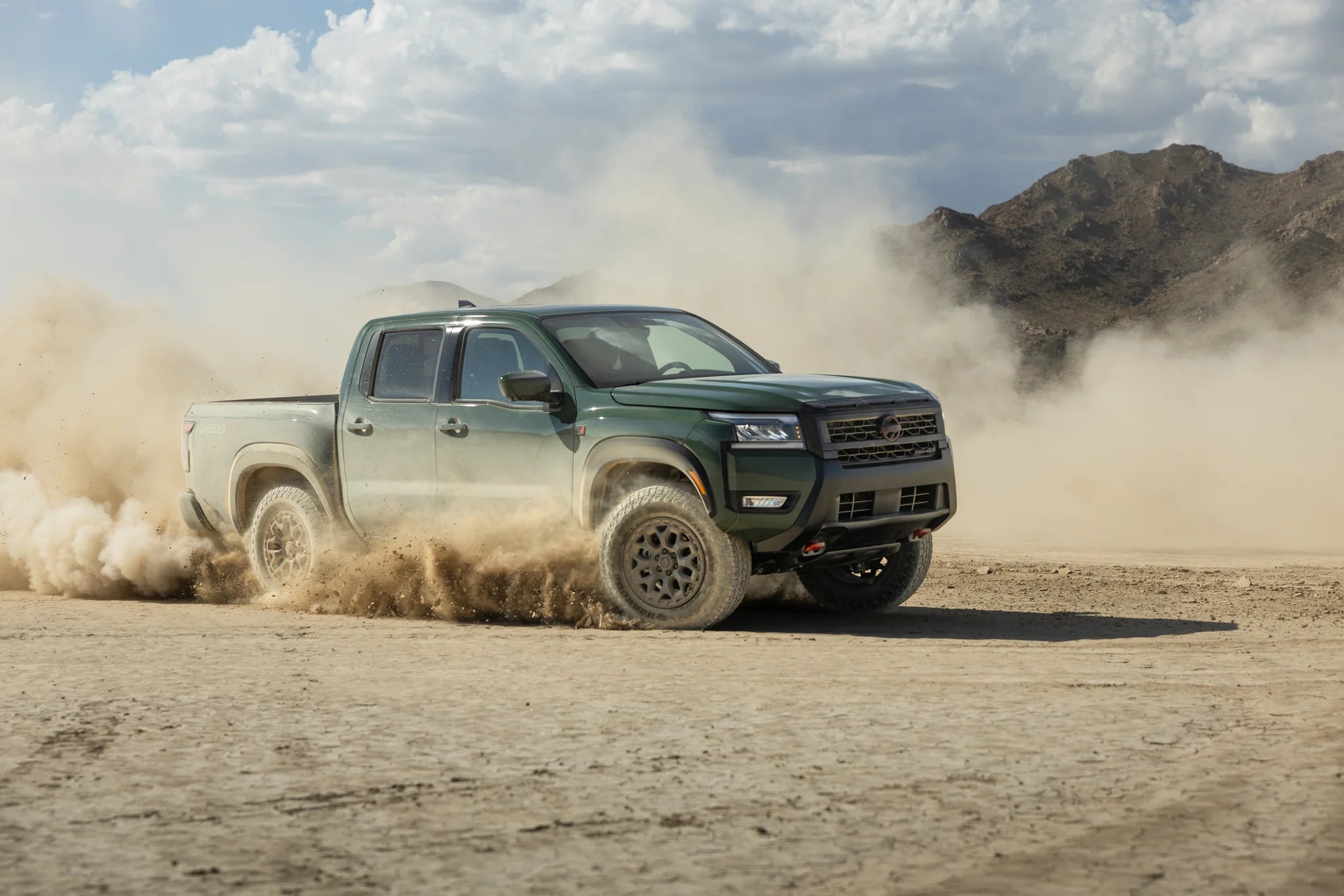 2026 nissan frontier driving on a dirt path