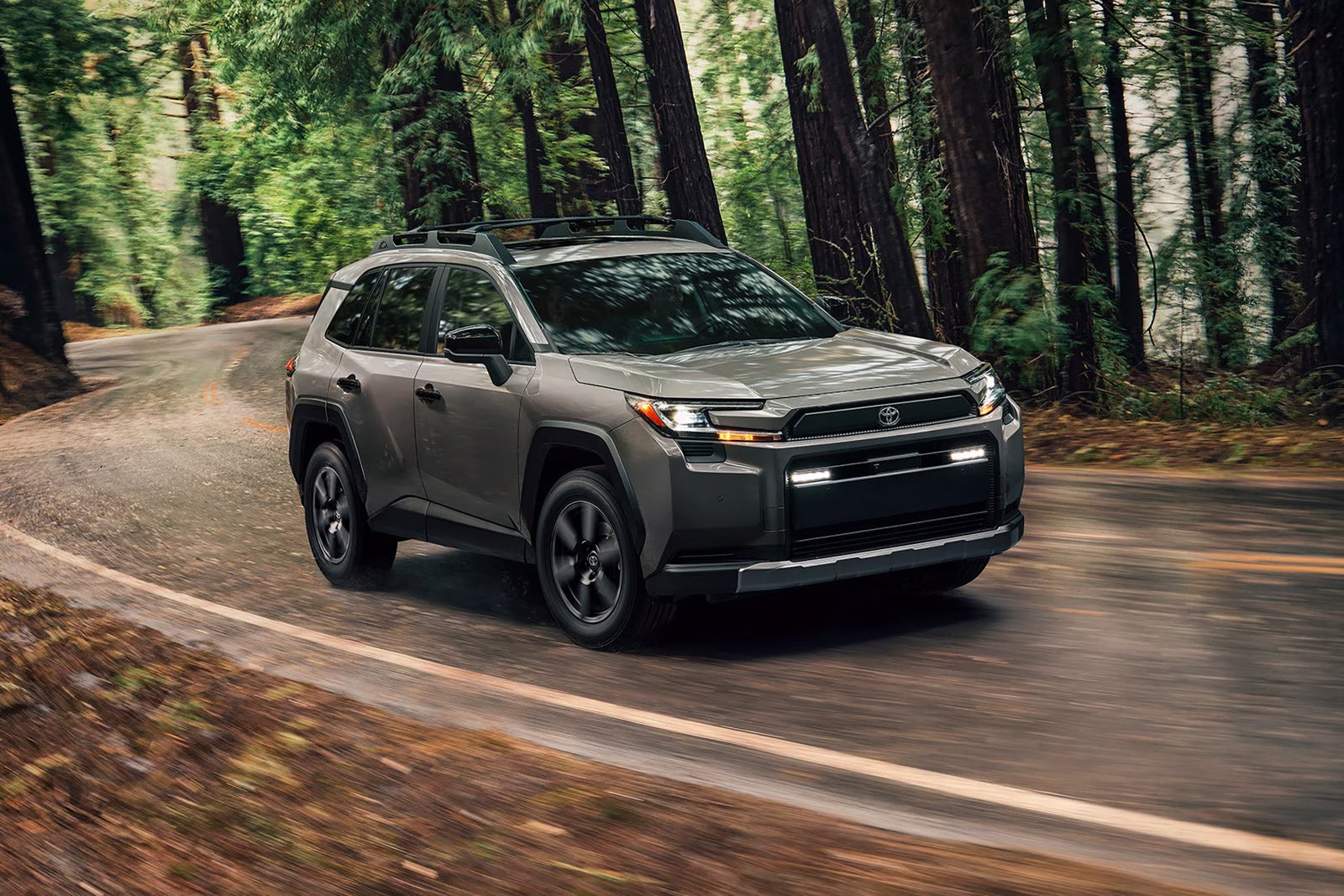 A gray suv driving on the road.