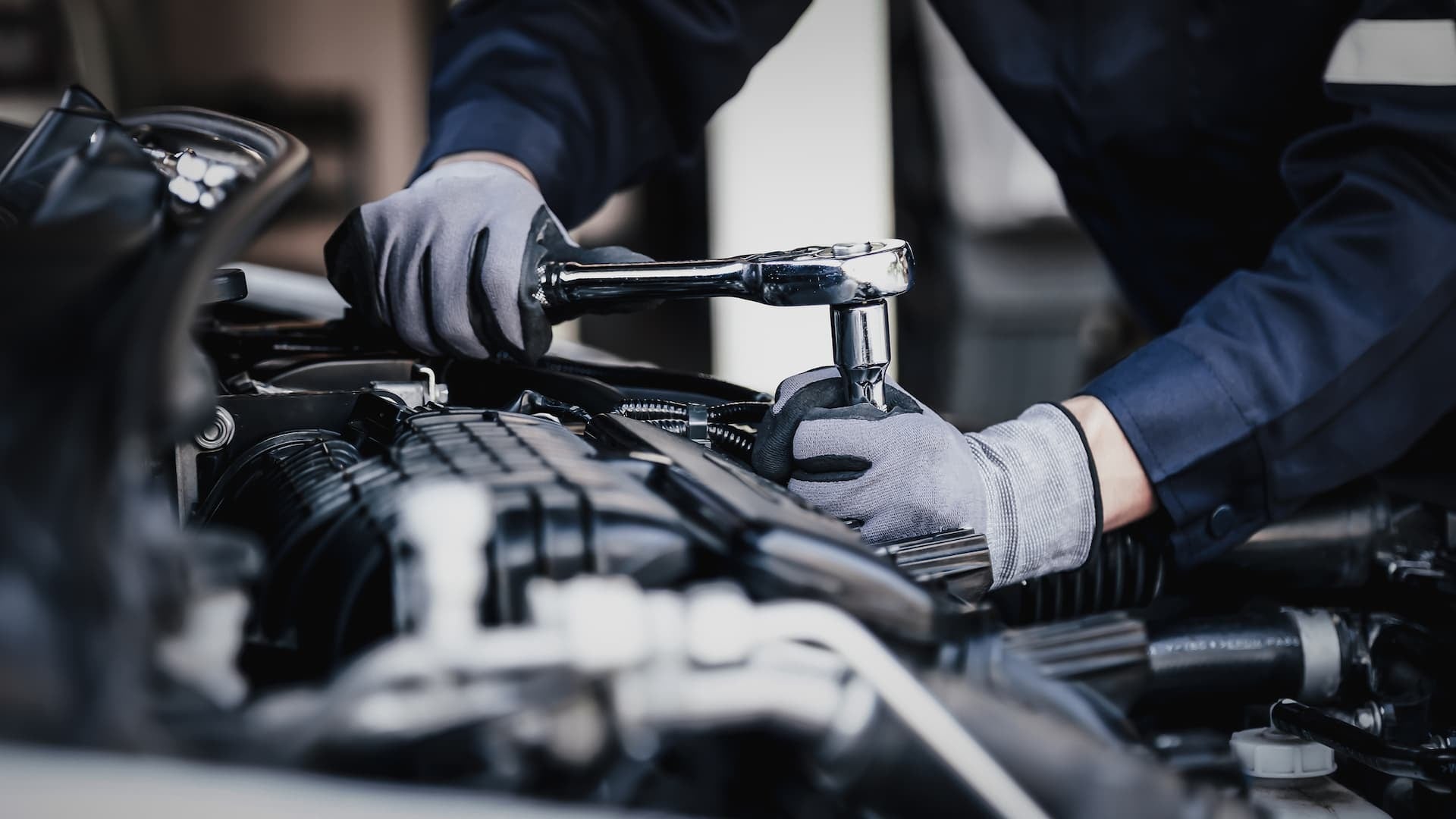 Certified Nissan technician servicing a car.