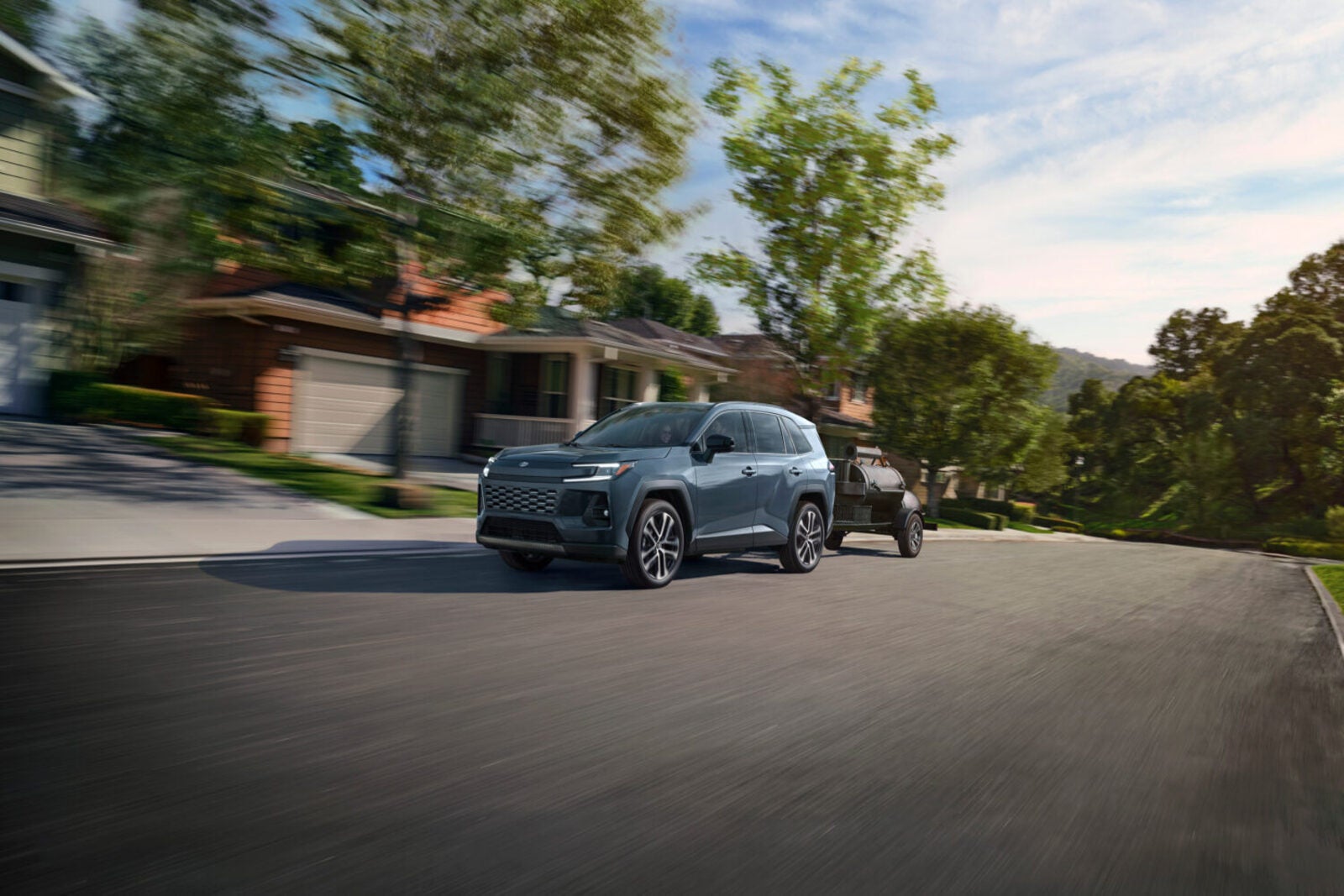 A blue suv pulling a trailer.